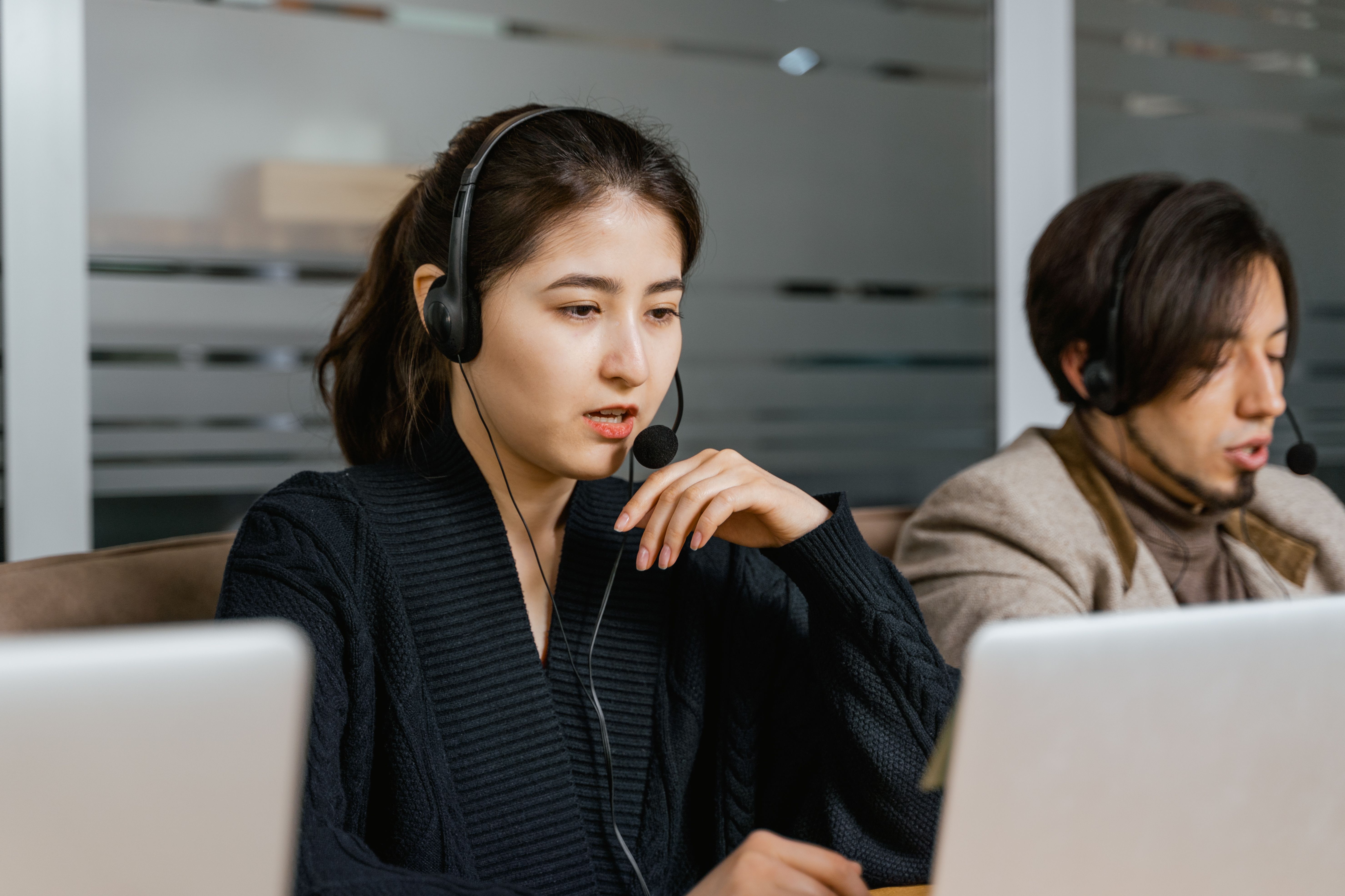 Customer service representative recording information on computer